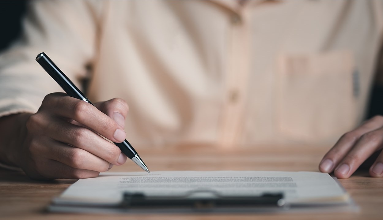 PHOTO: A person signing a contract